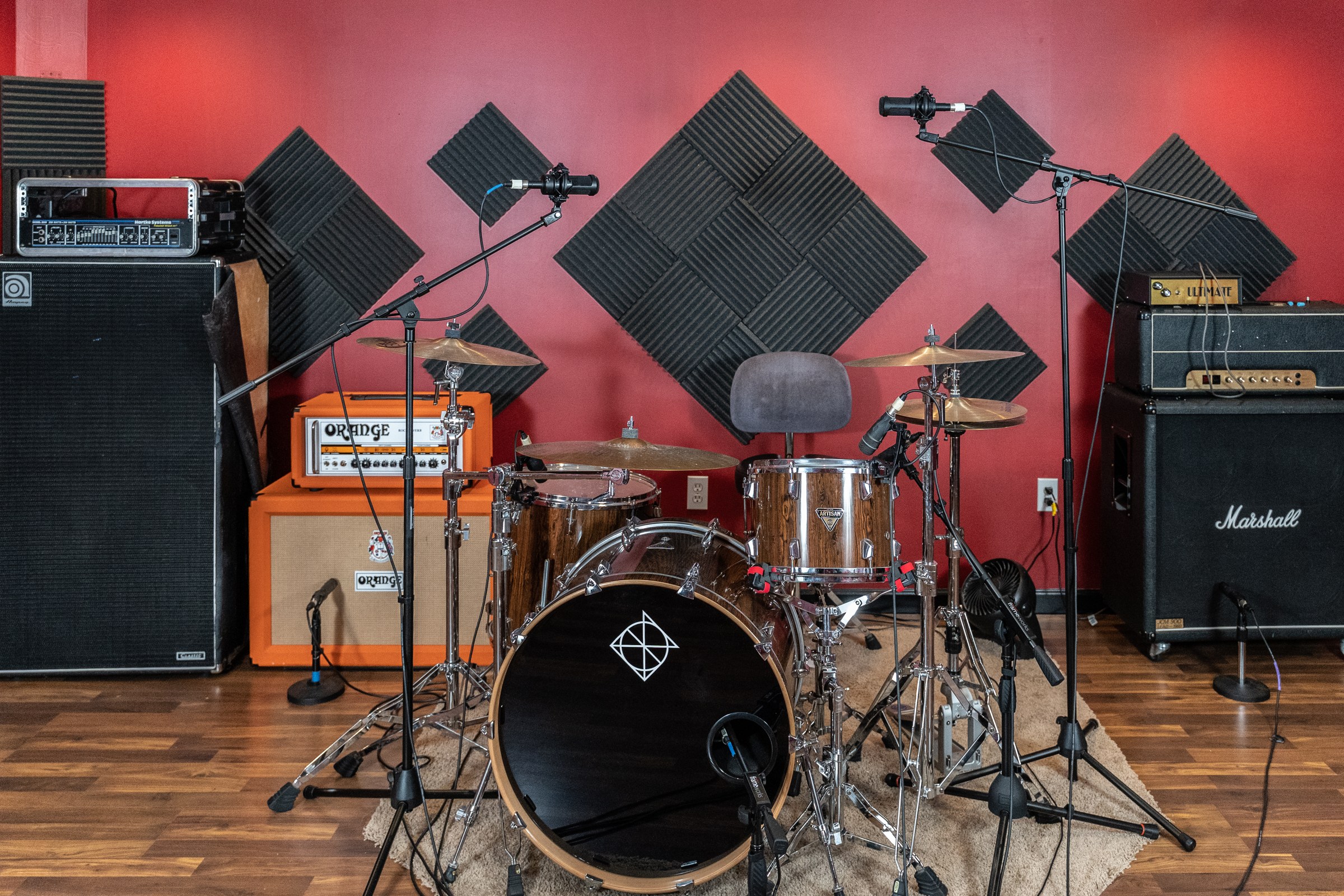 Miguel’s studio drum kit with microphones, cymbals, and amplifiers.